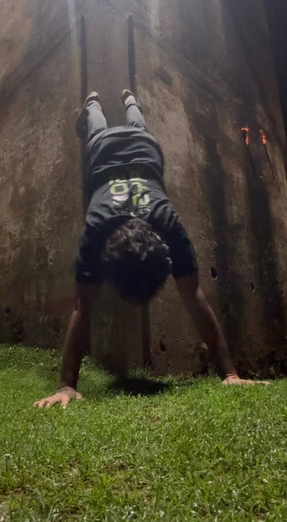 practicing a handstand outside