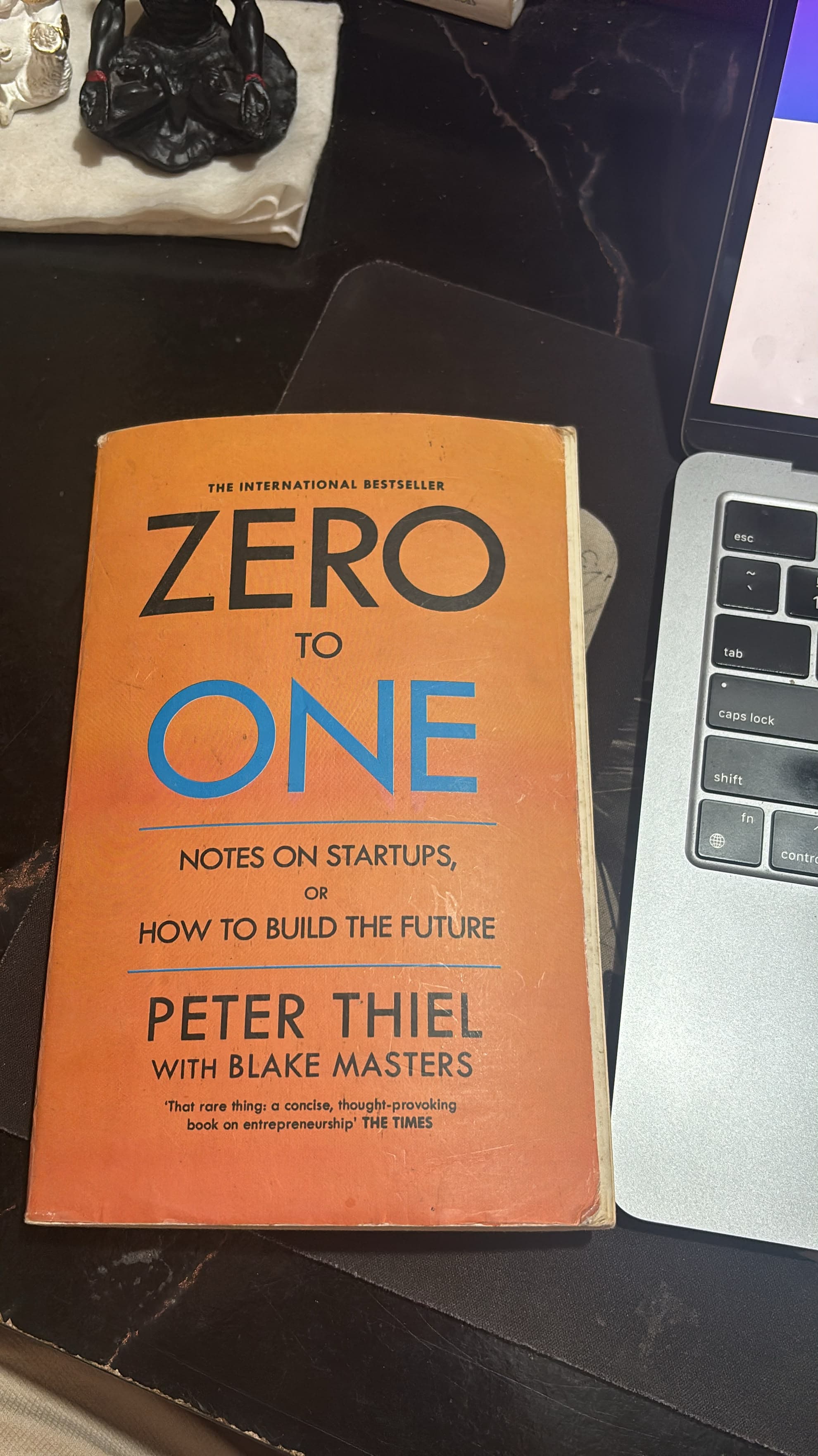 zero to one beside a laptop
