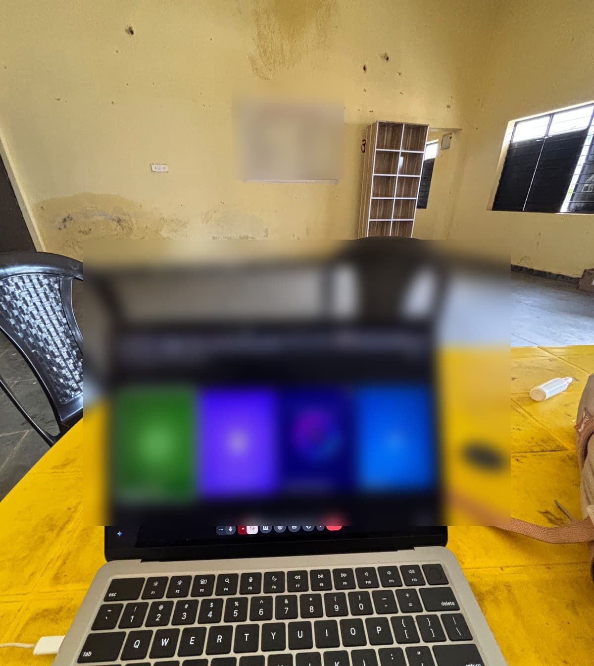 a laptop on a yellow table during the first feedback call